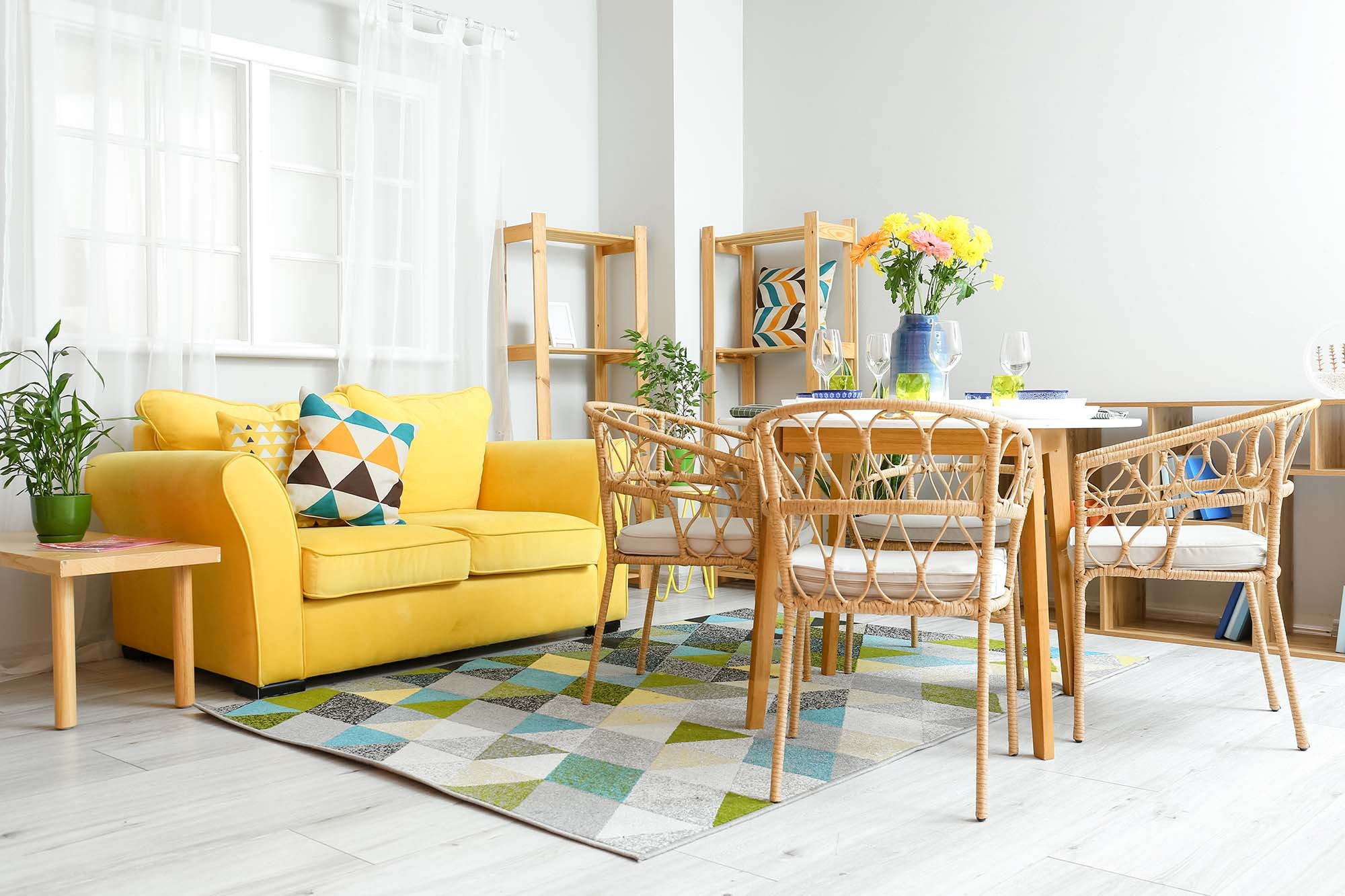 yellow couch and brown chairs and coffee table on a colorful patterned area rug from Henson's Greater Tennessee Flooring in Knoxville TN